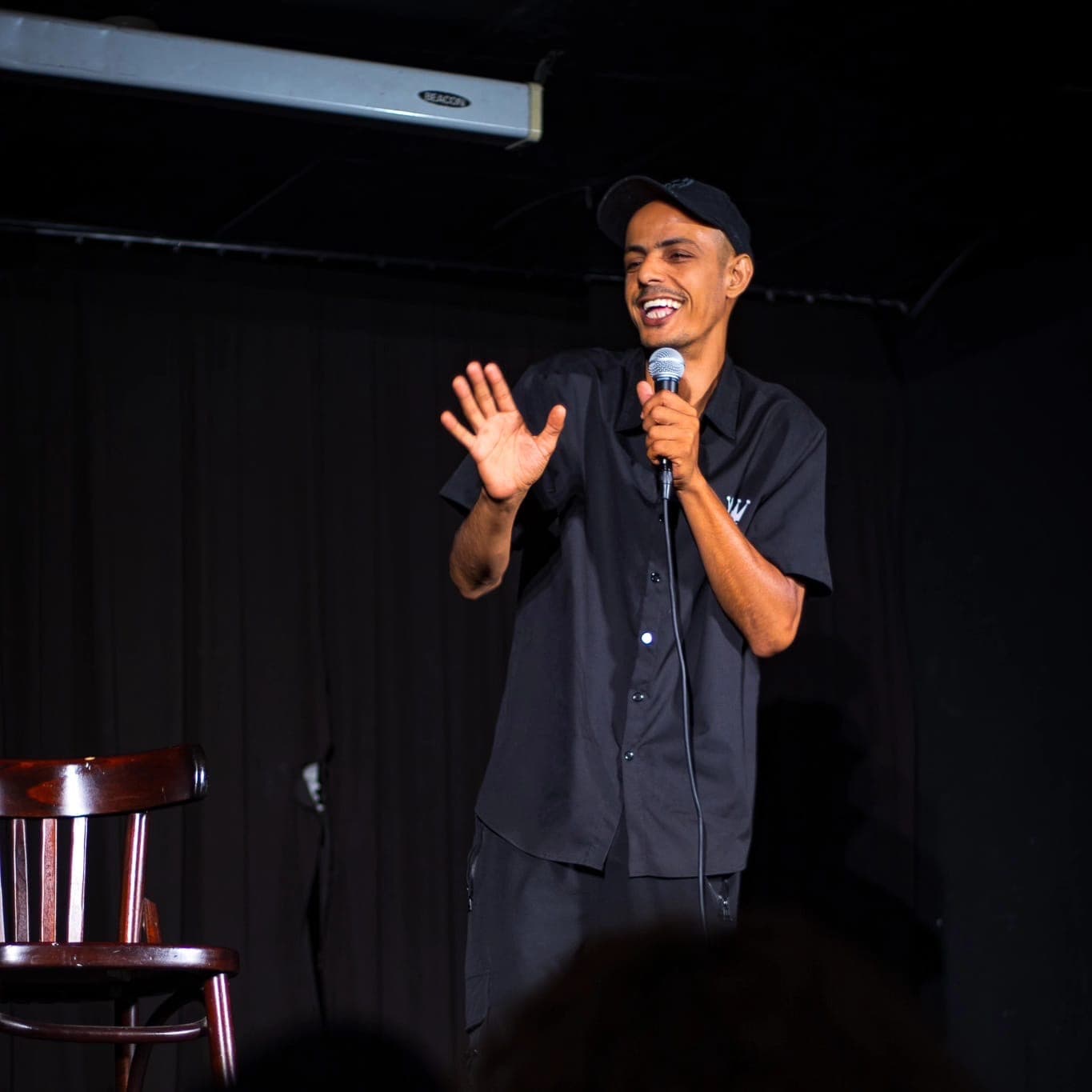 Mohammad Namma interacting with live audience during bilingual comedy show, building cultural bridges through humor
